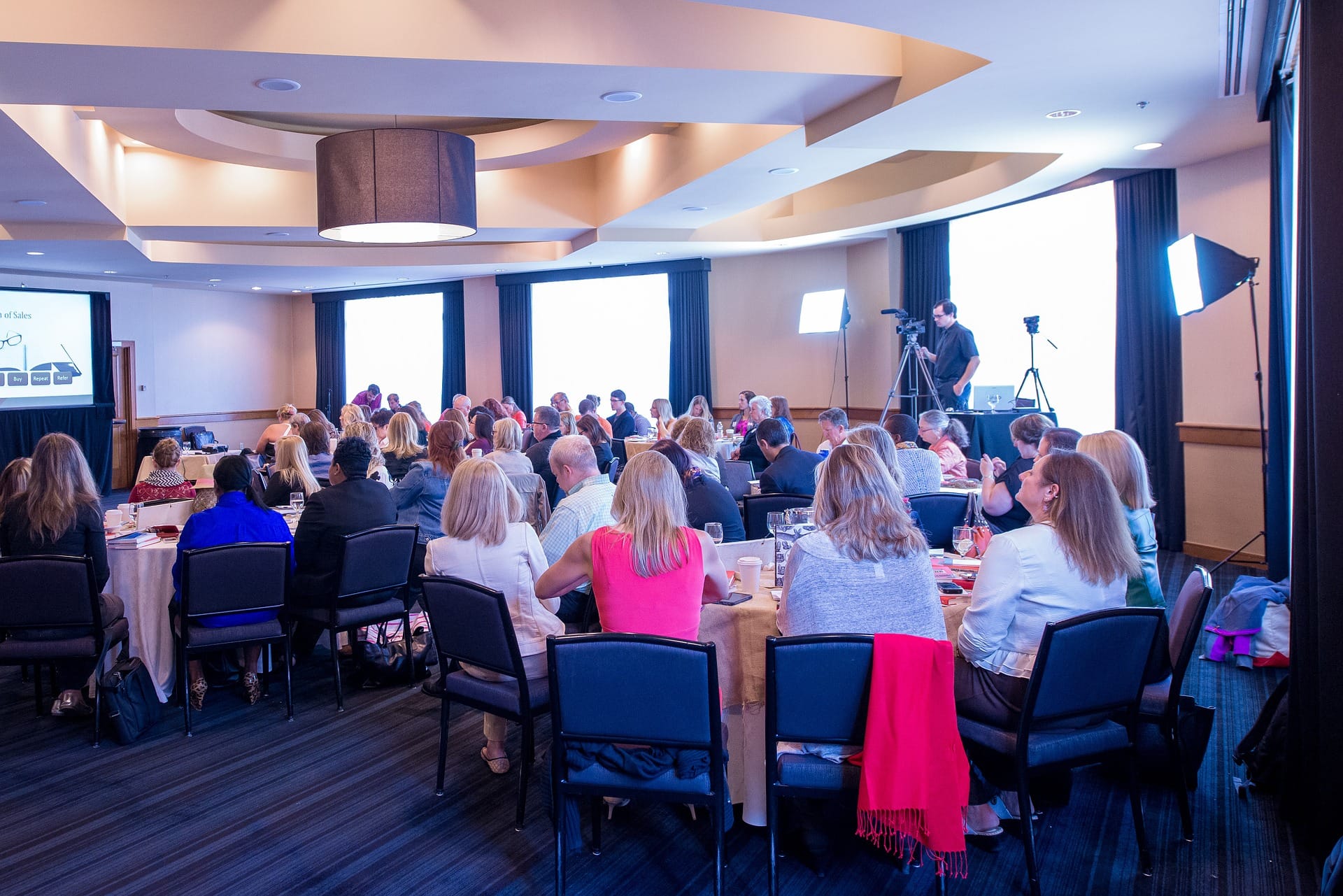 Bloggers attending a blogging conference, watching a speaker give a presentation.